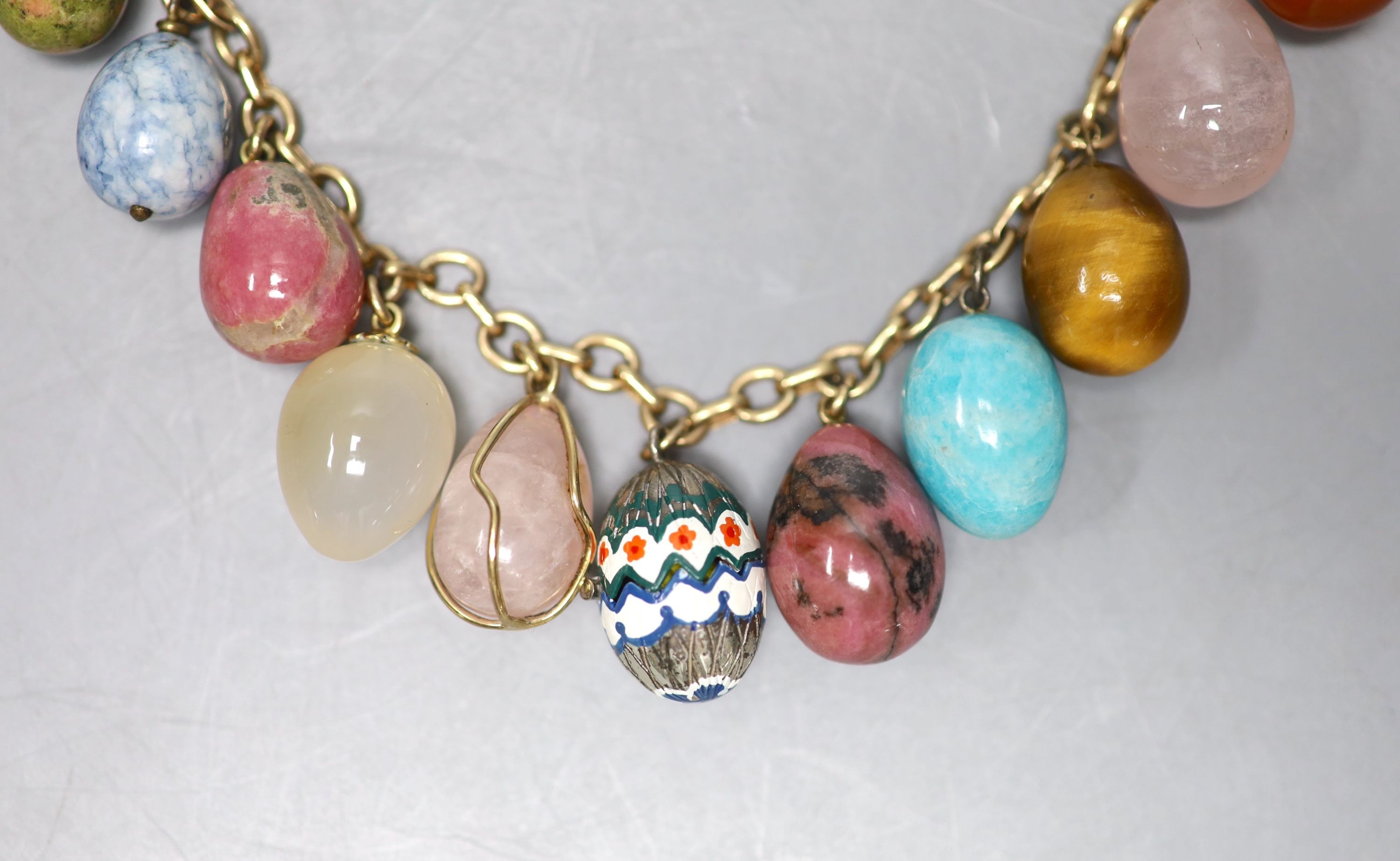 A 9ct gold and egg shaped specimen hardstone and enamelled charm set necklace, 70cm, gross weight 198.6 grams.